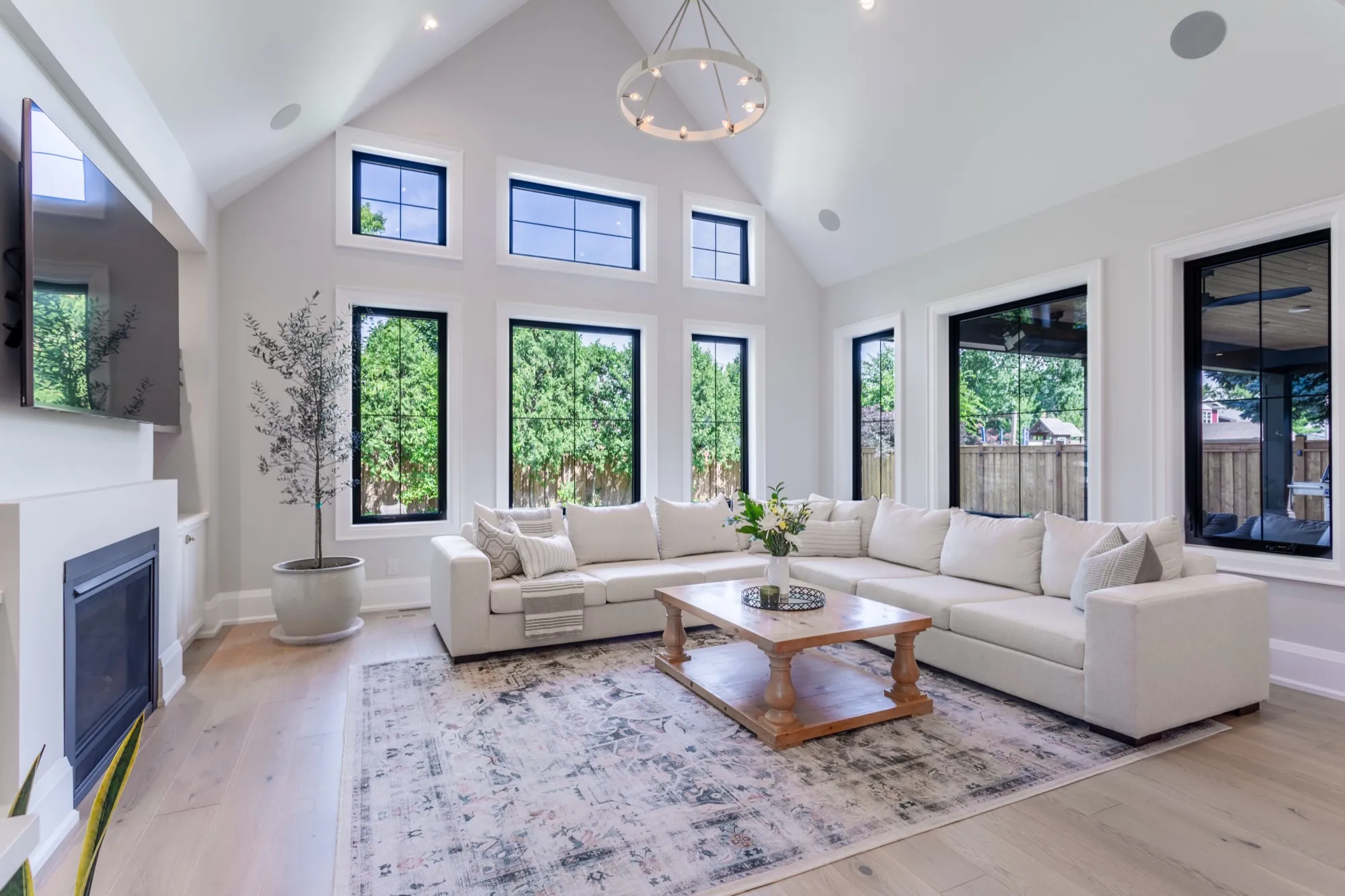 Bright great room with vaulted ceilings and tall windows