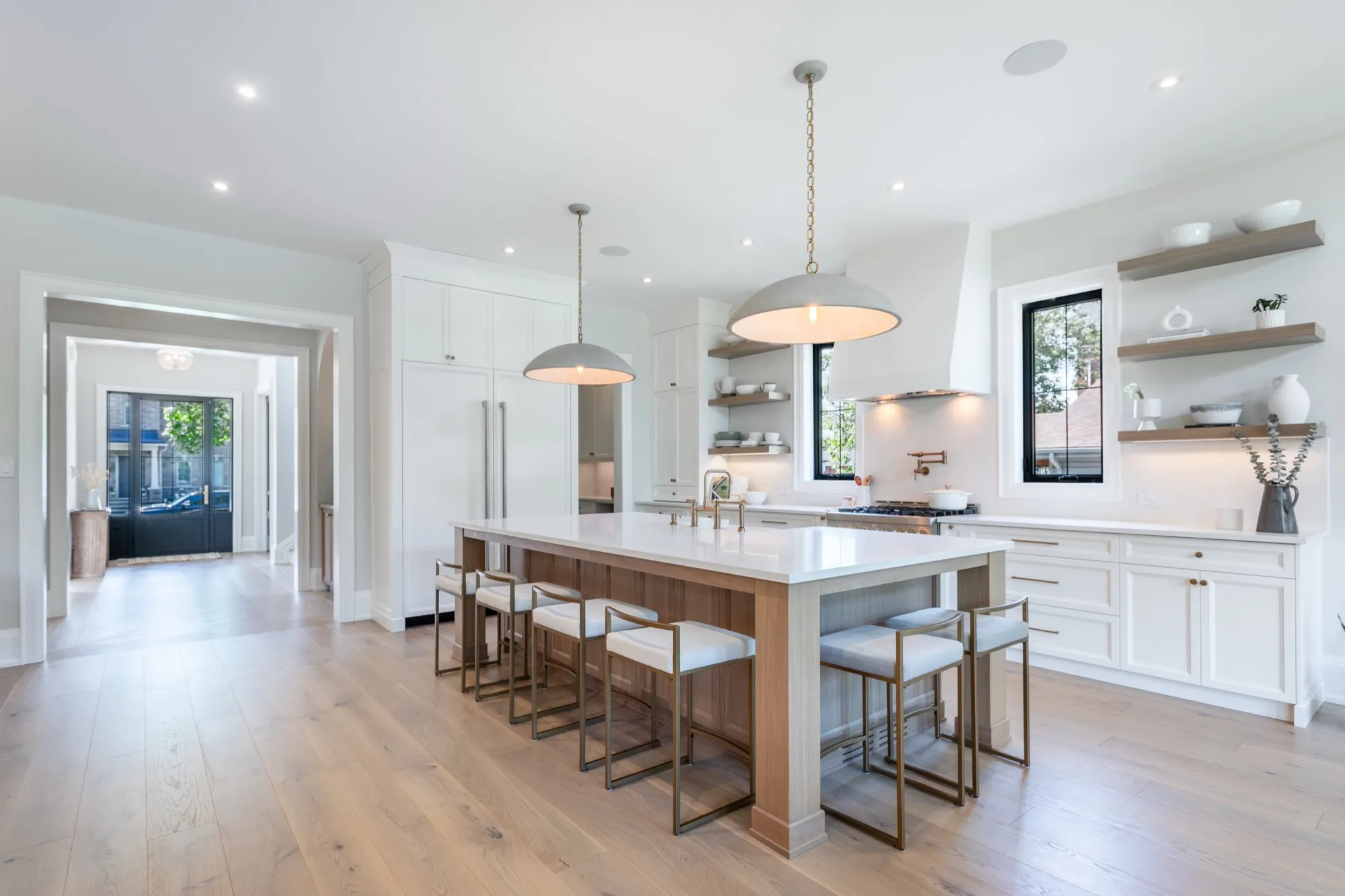 Staged kitchen with a long island and pendant lights