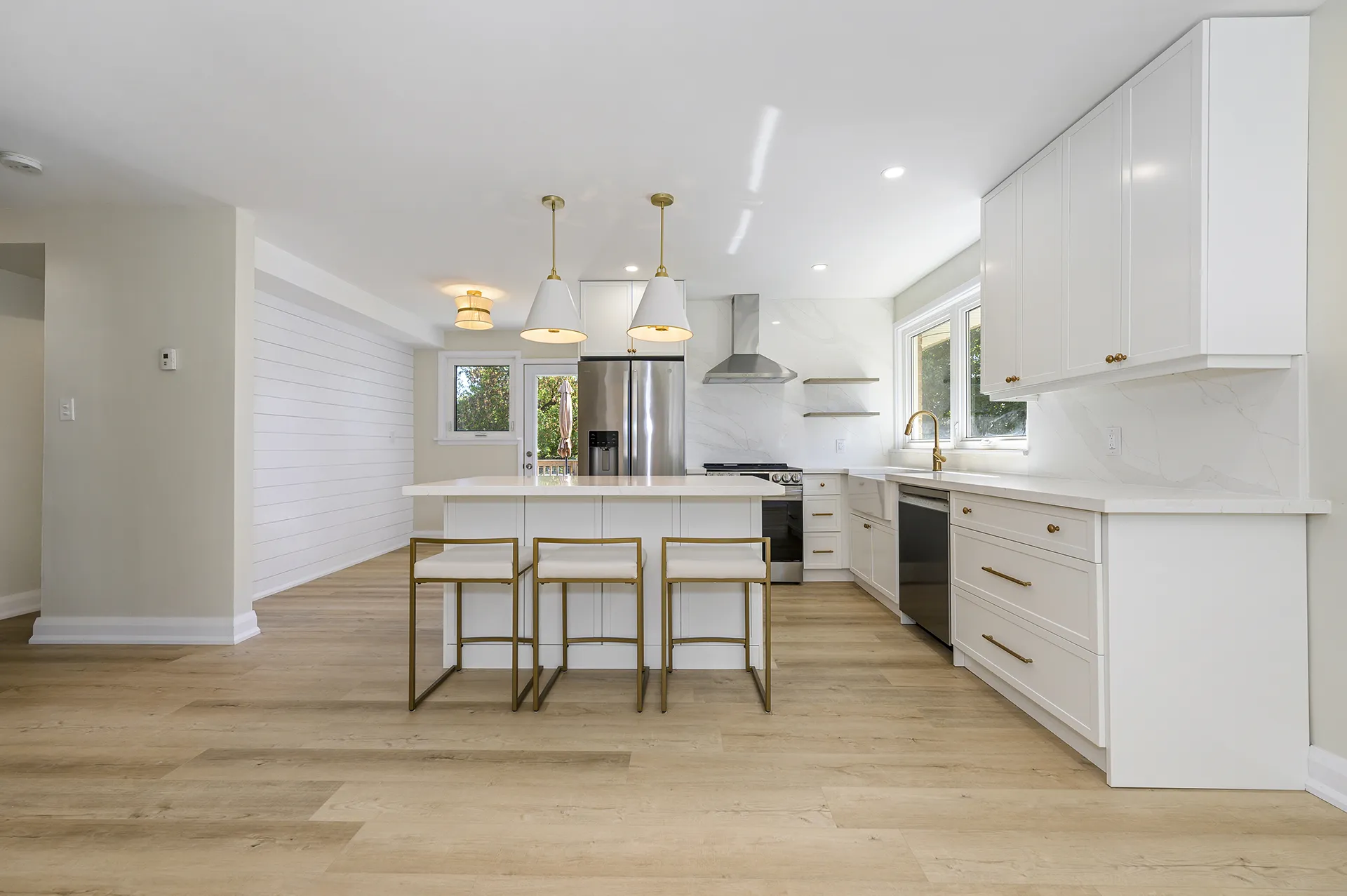 Renovated white kitchen with an island